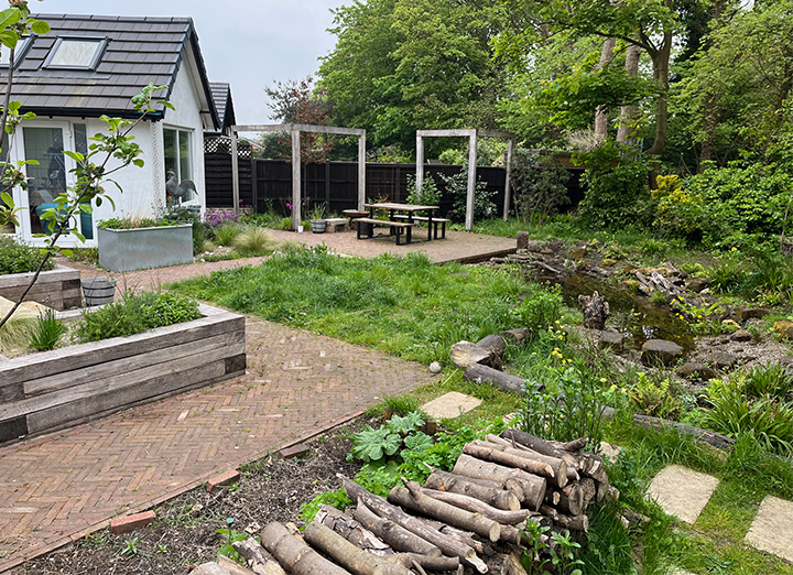 Garden weaves rain water through the garden from the roof and rain planter on the left to the pond on the right